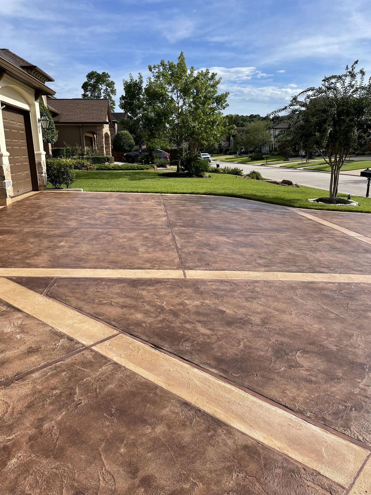 Acid stained concrete driveway with saw-cut borders in Tampa, FL