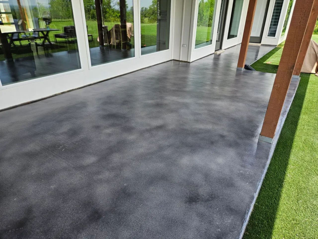 Charcoal stained concrete patio with a sealed finish in Tampa, FL