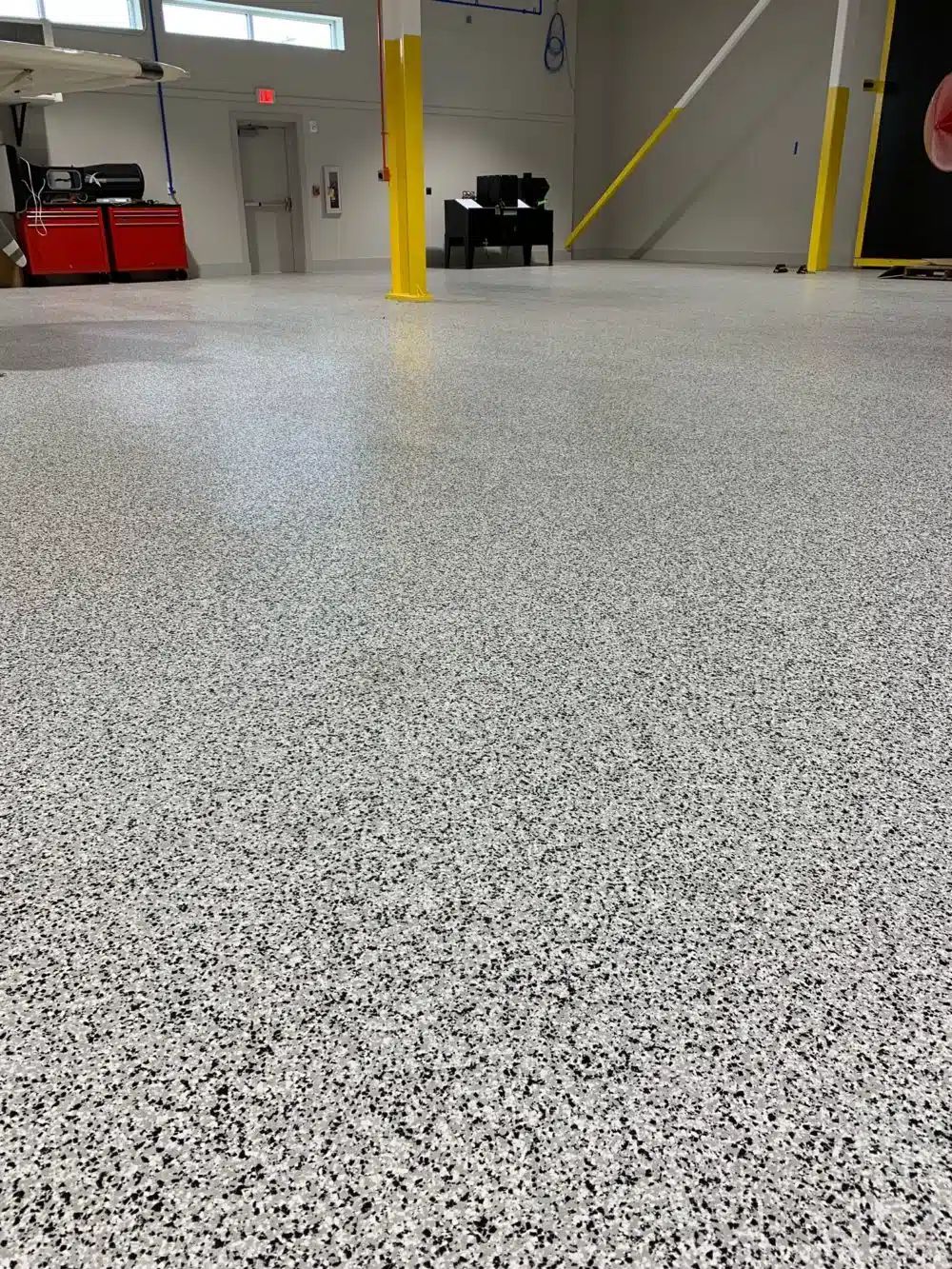 Black and white flake epoxy garage floor with polyaspartic topcoat in Tampa, FL