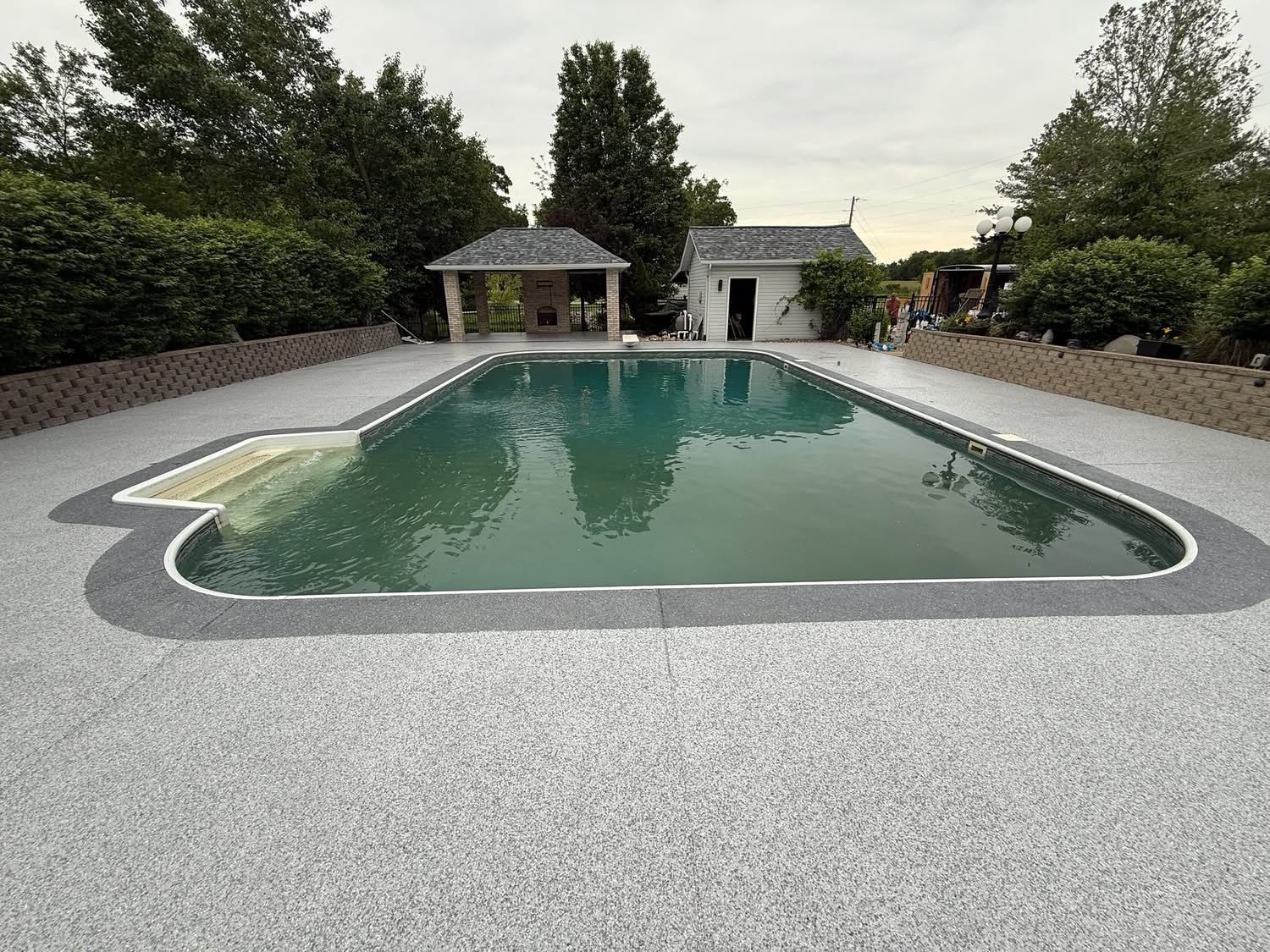 Flake coated pool deck with contrast border in Tampa, FL